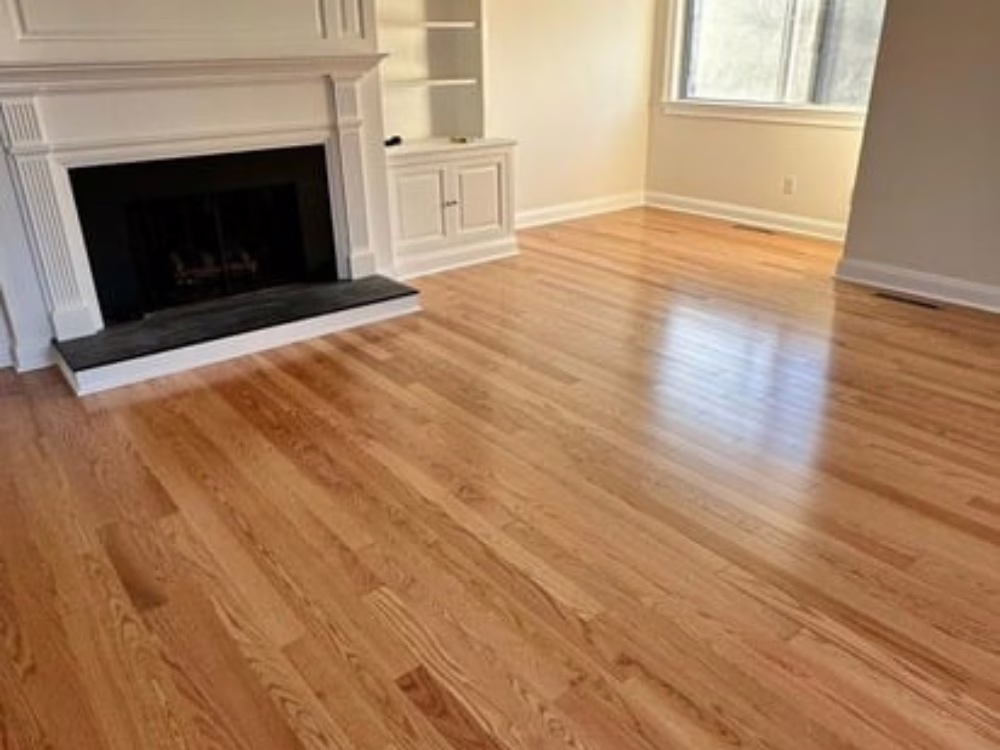 Living room featuring newly installed Red Oak Planks hardwood flooring with natural finish and elegant wood grain.