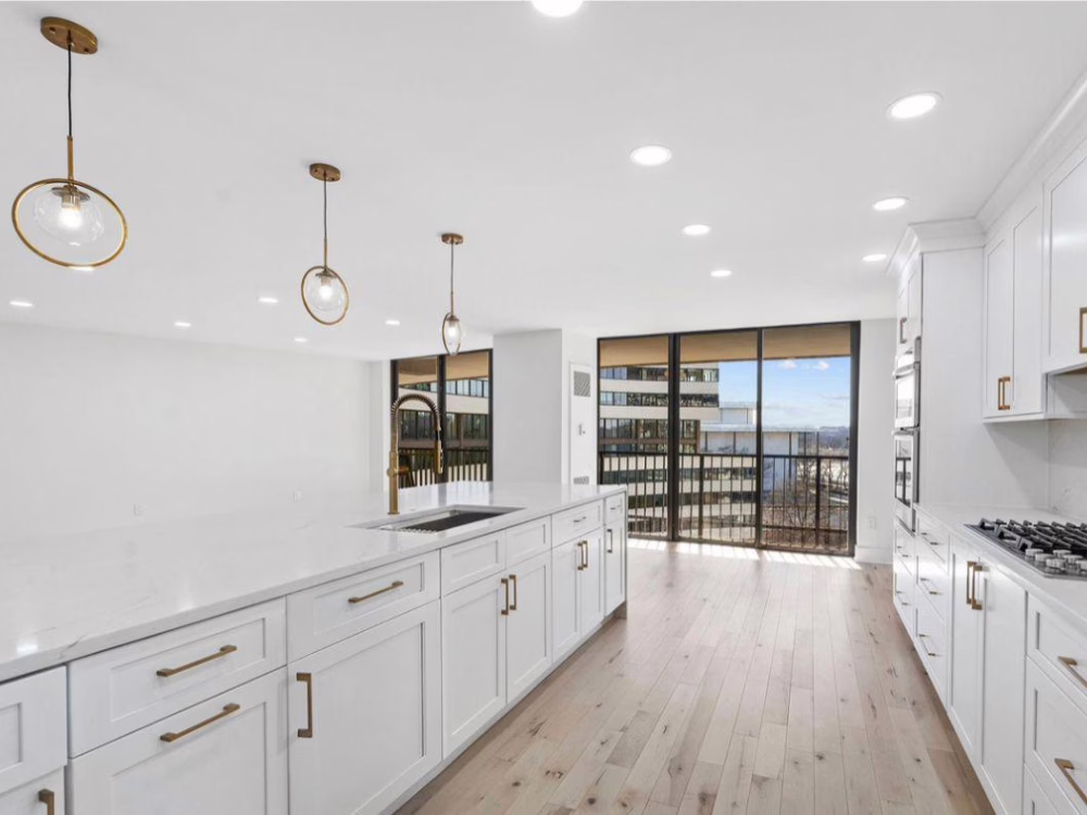 Kitchen Remodeling - Apartment with modern white cabinetry and sleek countertops.