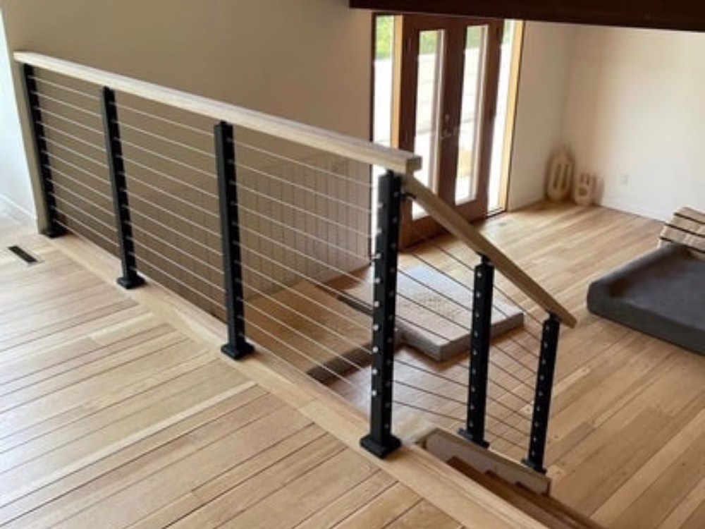 Sleek and minimalist handrail design with wood and metal elements in an open space.