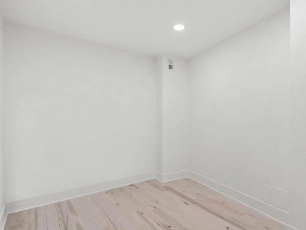 basement painting with white walls and light wood floor